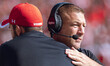 Wisconsin Badgers Offensive Coordinator Phil Longo embraces a member of the coaching staff...