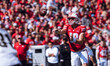 Wisconsin Badgers quarterback Braedyn Locke #18 throws a pass while on the run against the...