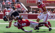 Wisconsin Badgers cornerback Xavier Lucas #6 sends Purdue running back Devin Mockobee #45...