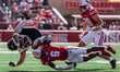 Wisconsin Badgers cornerback Xavier Lucas #6 sends Purdue running back Devin Mockobee #45...