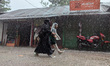 Children return from school during heavy rain in Feni, Bangladesh, on October 6, 2024. Cli...