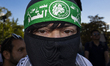 A person poses for photographs during a pro-Palestinian rally as part of an international...