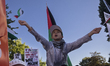 A boy chants and shows Palestinian flags during a pro-Palestinian rally as part of an inte...