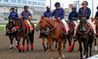 Outriders gather on the track after a race at Woodbine Racetrack in Toronto, Canada, on Oc...