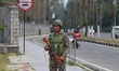 An Indian paramilitary soldier guards outside a vote counting center for the local assembl...