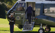 U.S. President Joe Biden salutes a U.S. Marine as he boards Marine One on the South Lawn o...
