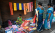 A woman sells garments inside a market in Kolkata, India, on October 10, 2024. 