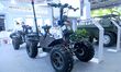 An exhibitor displays an all-terrain powered skateboard carrier at the 9th China Advanced...