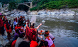 Hindu devotees immerse an idol of the Hindu goddess Durga into the Bagmati River in Kathma...