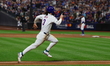 Jesse Winker #3 of the New York Mets scores on a sacrifice fly during the sixth inning in...