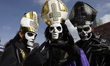 Three people dress as the lead singer of the band Ghost during the Zombie March in Mexico...