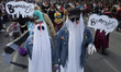 Dozens of people dressed in costume participate in the Zombie March in Mexico City, Mexico...