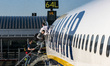 Passengers waiting in line and boarding a Ryanair low cost airline airplane at London Stan...
