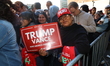 A Trump supporter holds up a sign while awaiting entrance to a campaign rally for Republic...