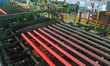 A worker works in a workshop of Zhejiang Minghe Steel Pipe Co., LTD., located in Moganshan...