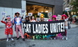 People hold up a banner uniting cat ladies for New York's 51st Annual Village Halloween Pa...