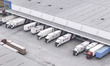 Express trucks from several companies load and unload parcels at a logistics park in the H...