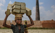 Lubna is a 13 year old girl who is lifting bricks on her head, in Dhaka, Bangladesh, on Ap...