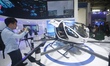 Visitors view the EH216-S electric vertical takeoff and landing unmanned manned aircraft (...