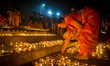 A lady lights oil lamps at the riverside of the Ganges in Kolkata, India, on November 15,...
