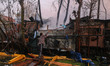 Civilians work to extinguish a fire on residential houses in Srinagar, Jammu and Kashmir,...