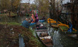People transport their belongings in boats as firefighters and civilians work to extinguis...
