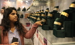 A woman examines diamond bangle jewelry inside a stall at East India's International Gems...