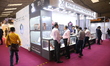 Traders look at diamond jewelry inside a stall at East India's International Gems and Jewe...