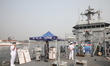 Naval officers stand on INS Savitri during the Navy Week celebrations at the Khidderpore D...