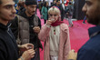A young Iranian woman tastes a coffee while visiting the Iran Coffee Expo at the Iran Mall...