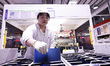 Workers produce export photovoltaic modules in a new energy 5G intelligent workshop in Suq...