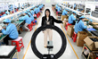 A staff member of an electronics company helps job seekers understand the working environm...
