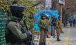 An Indian security personnel stands guard along a street in Srinagar, Jammu and Kashmir, o...