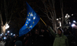 An anti-government protester waves a European Union flag during a demonstration against th...