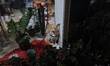 A small dog sits in the decorated window display of a florist shop in Athens, Greece, on D...