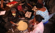 Women make their customized Christmas fruit cake with their own ingredients inside a tradi...