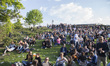 People sit on the gras of the Goerlitzer park during the annual MyFest in the Kreuzberg di...