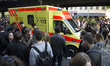 An ambulance proceeds through the crowd during the annual MyFest in the Kreuzberg district...