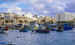 Hundreds of colorful fishing boats moor in Marsaxlokk harbor in Marsaxlokk, Malta, on Dece...