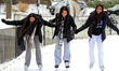 Three friends help each other skate around the Gage Park ice rink in downtown Brampton, On...