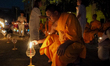 A number of novice monks, known as 'Samanera,' light candles during the Light of Peace cer...