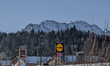 A view of Aldi Sud and Lidl supermarket signs is set against the backdrop of snow-covered...