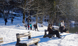 People walk around the Bavarian Lake Alpsee on a cold winter day in Schwangau, Fussen, Eas...