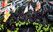 Members of the Korean Confederation of Trade Unions (KCTU) and citizens scuffle with polic...