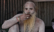A Sadhu, or a Hindu holy man, drinks tea at a makeshift shelter before heading for an annu...