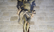 The large cross at the right entrance of the Basilica of Saint Nicholas in Bari, Italy, is...