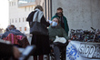 A young woman with disabilities speaks to a journalist during the gathering. The NGO Handi...