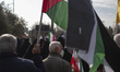 Iranian worshippers carry Iran's and Palestinian flags while participating in an anti-Isra...