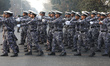Indian Air Force officers raise their arms as they perform before participating in the reh...