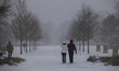 A couple walks through Memorial Park during a snowstorm in Houston, Texas, on January 21,...